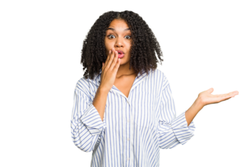 Young african american woman isolated impressed holding copy space on palm.