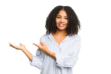 Young african american woman isolated excited holding a copy space on palm.