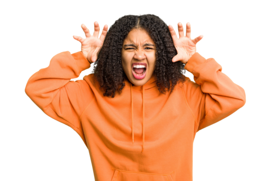 Young african american woman isolated showing claws imitating a cat, aggressive gesture.