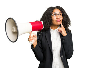 Young african american business woman holding and screaming with a megaphone isolated