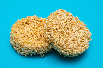 Uncooked Instant Noodles on Blue Background. Raw Pasta. Dry Asian Fast Food. Quick Lunch