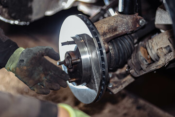 installation and replacement of car brake discs in a car service.