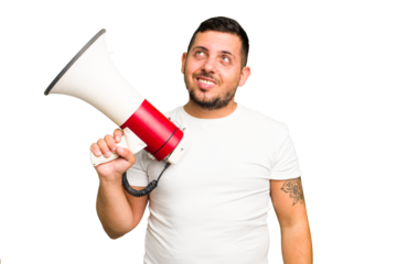 Young caucasian man holding a megaphone isolated dreaming of achieving goals and purposes