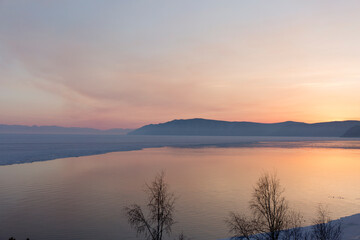 Fototapeta premium Beautiful sunset on frozen lake Baikal. Winter landscape.