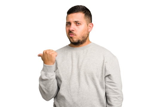 Young caucasian man isolated shocked pointing with index fingers to a copy space.