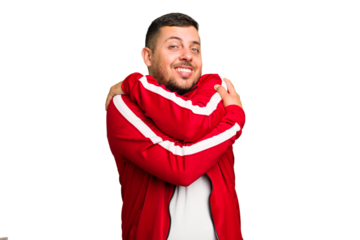 Young caucasian man isolated hugs, smiling carefree and happy.
