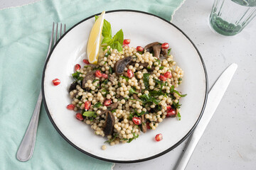 Couscous salad with mushrooms and pomegranate