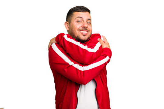 Young caucasian man isolated hugs, smiling carefree and happy.