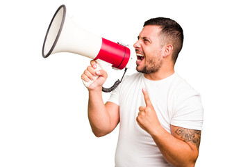 Young caucasian man holding a megaphone isolated - obrazy, fototapety, plakaty