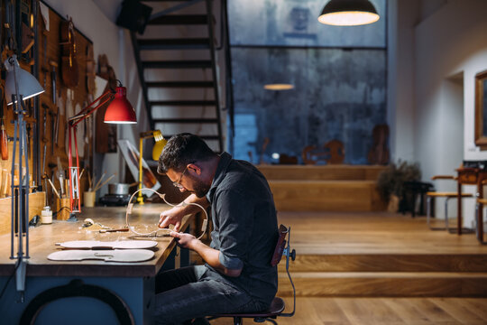 Luthier creating violin ribs in workshop