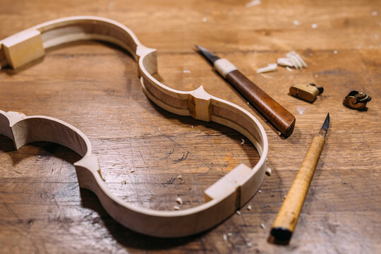 Chisels and violin ribs on workbench