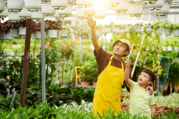 Father Showing Hanging Plants to Son