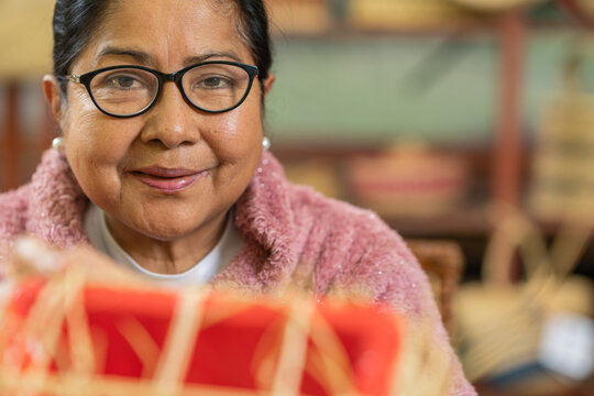 Mature Hispanic craftswoman in workshop