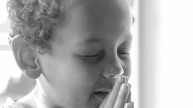 little boy praying to God with hands together on whit background stock video stock footage