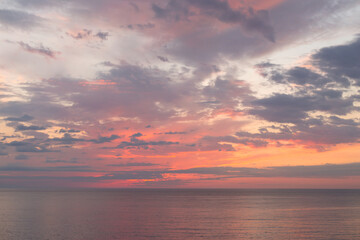 Naklejka na ściany i meble Calm sea with sunset sky with cloud.