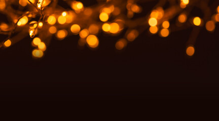 Christmas golden lights Background. Abstract twinkled bright bokeh defocused lights.