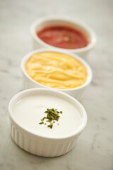 Mustard sauce and various sauces in a small bowl