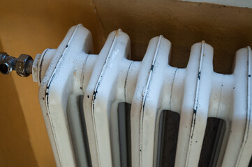 Detail of an old radiator. The central heating system in the house. Warm home concept.