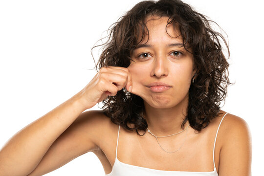 Portrait Of Young Etnic Woman, Pulling Her Cheek Skin On White Background