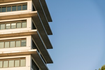 Low-angle view of a residential building's exterior under the blue sky