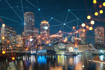 City view panorama of Boston Harbor and Seaport Blvd at night time, Massachusetts. Exteriors of...