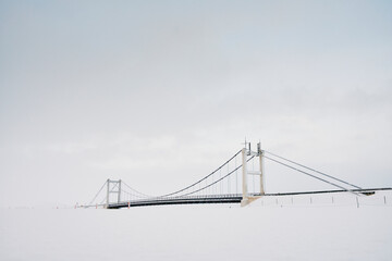 Bridge over frozen river in winter