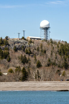 An air traffic radar tower perched on a hill above Jasper Beach in Bucks Harbor, Maine
