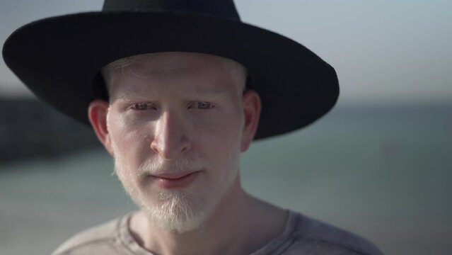 Albino man close up portrait at the beach
