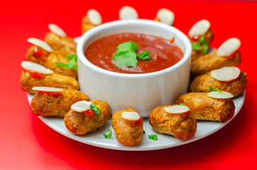Halloween bloody fingers, pork cocktail sausages decorated with flaked almonds served with tomato...