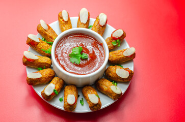 Halloween bloody fingers, pork cocktail sausages decorated with flaked almonds served with tomato...