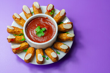 Halloween bloody fingers, pork cocktail sausages decorated with flaked almonds served with tomato...
