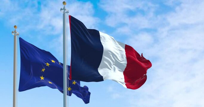 the flags of France and the European Union waving in the wind
