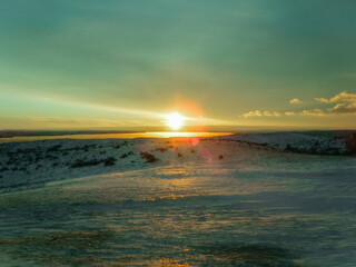 Yellow and blue sunset over snowy landscape