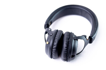 Headphones, cover, black leather, stereo jack, coiled on a white background.