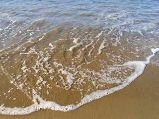 Ocean water on sandy beach