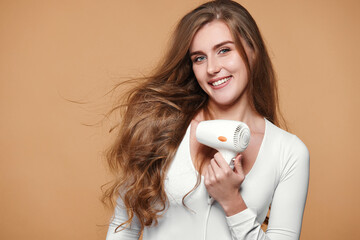 woman with strong healthy hair using hair dryer