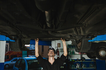 Mechanic examining car in workshop
