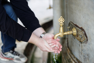 Closeup of water taps for ablution before visiting a mosque in Islamic culture. Mosque in Istanbul