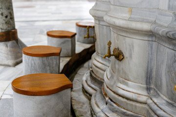 Closeup of water taps for ablution before visiting a mosque in Islamic culture. Mosque in Istanbul
