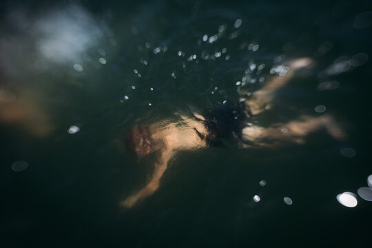 Young child in lake swimming underwater