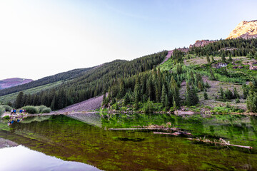 Fototapeta na wymiar Aspen, Colorado Maroon Bells wide angle view in summer water reflection, people standing with tripods taking pictures