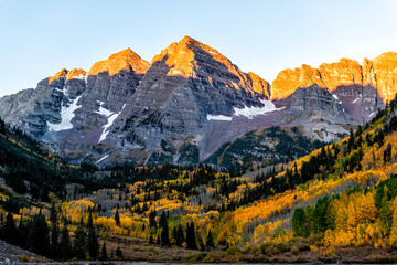 Maroon Bells dark peak at lake with sunrise sunlight in Aspen, Colorado rocky mountains in October...