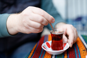 Traditional Turkish tea that is drunk near a cafe on the market street of Istanbul