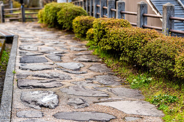 Stone paved path footpath in Takayama, Japan at Higashiyama walking course in historic city of Gifu Prefecture by Tounin temple shrines