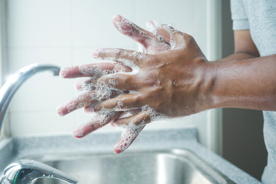 Young Man Washing Hands With Soap Warm Water 