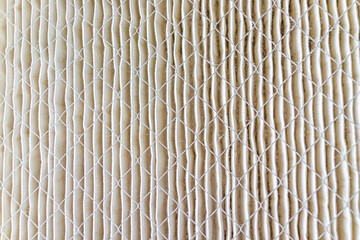 Macro closeup of dirty dusty AC air conditioner filter for home house with metal wire and paper...