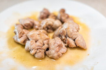 Macro closeup of fresh whole cooked fried beef sweetbreads thymus organ gland, nutritious ancestral...