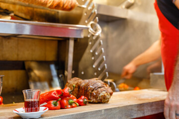 Chef cutting with doner knife Traditional Turkish Doner Kebab meat. Shawarma or gyros. Turkish, greek or middle eastern arab style chicken doner kebab food