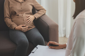 Panic, Stress asian young pregnant woman holding belly, abdomen while gynecologist consult symptoms...