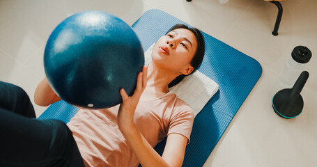 Close up of Young attractive sporty Asia strong woman in sportswear with calm feeling warming up...